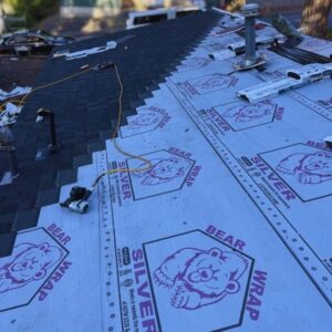 active reroof taking place using asphalt shingles bear wrap underlayment
