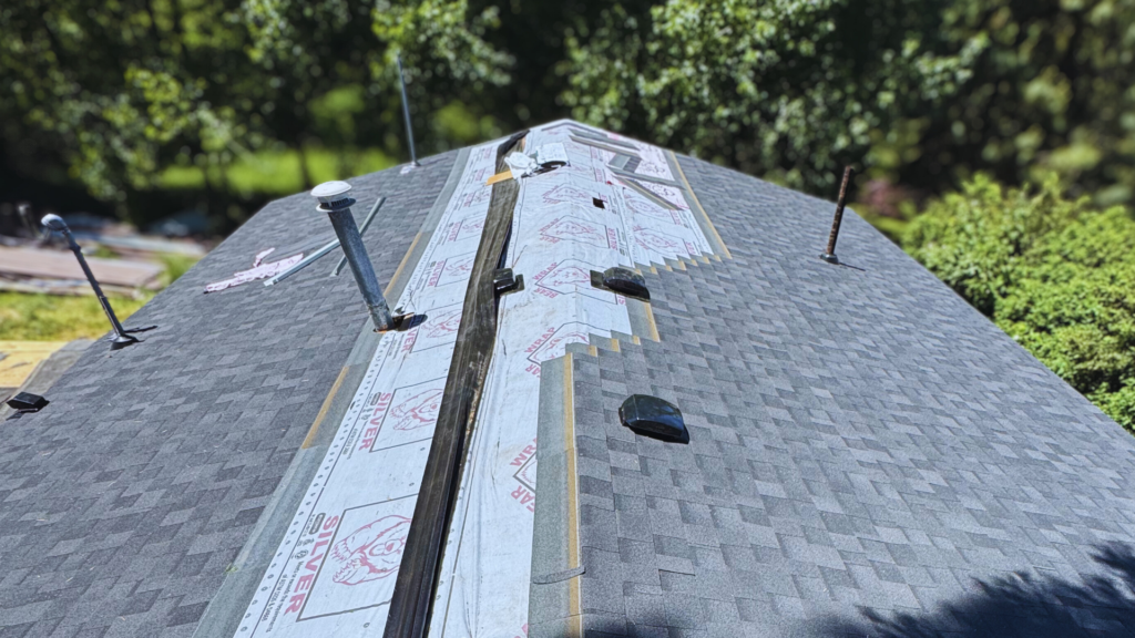 Licensed roofer installing asphalt shingles on a residential home in oregon
