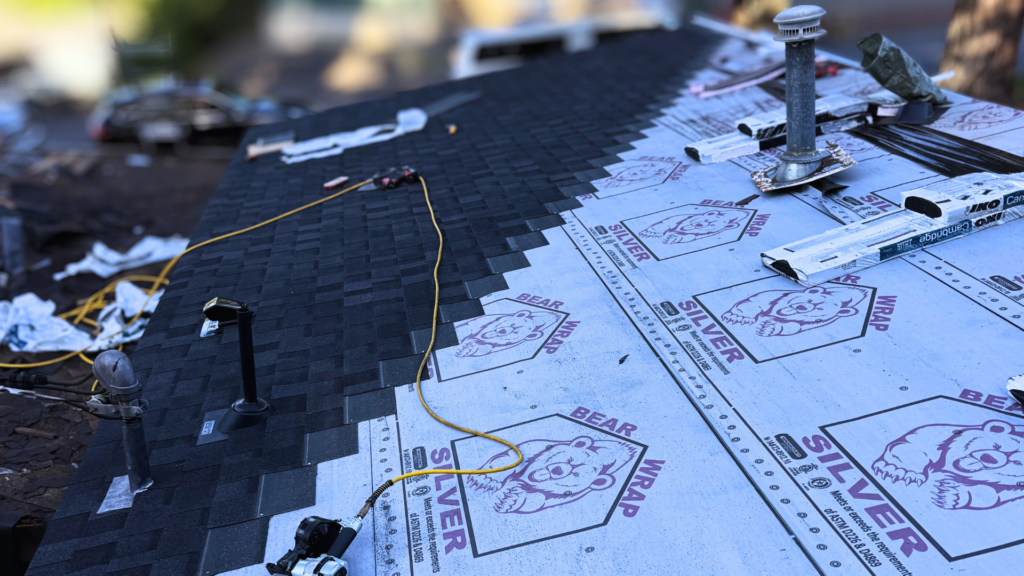 Licensed roofer installing asphalt shingles on a residential home