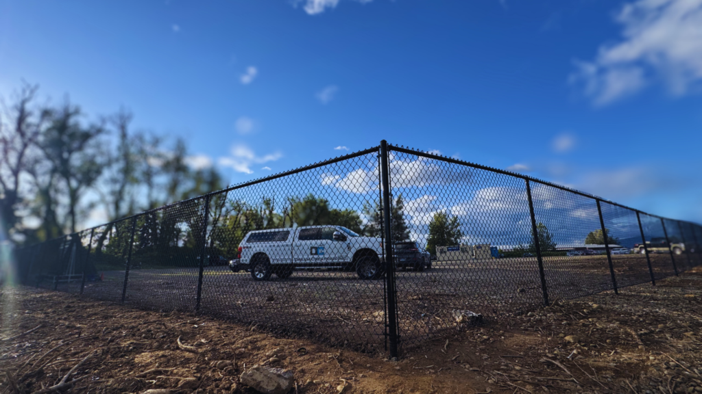 Professional fence contractor after installing a chain link fence