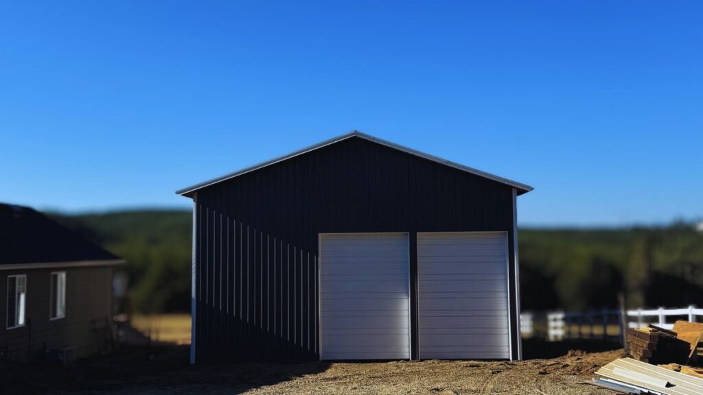 Exterior view of an oregon pole barn completed using dark grey metal
