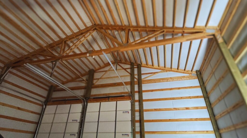 pole barn interior view of framing work under the roof