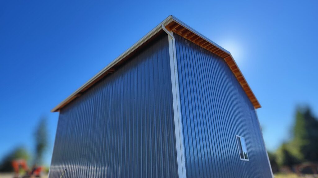 side view of dark grey metal pole barn completed by DCI