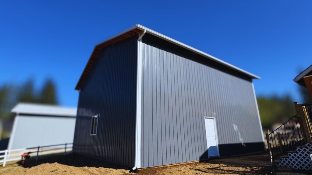 dark grey metal pole barn completed