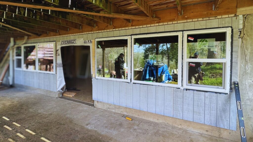 exterior view of newly built basement wall facing homeowners back garden post home remodeling work by DCI
