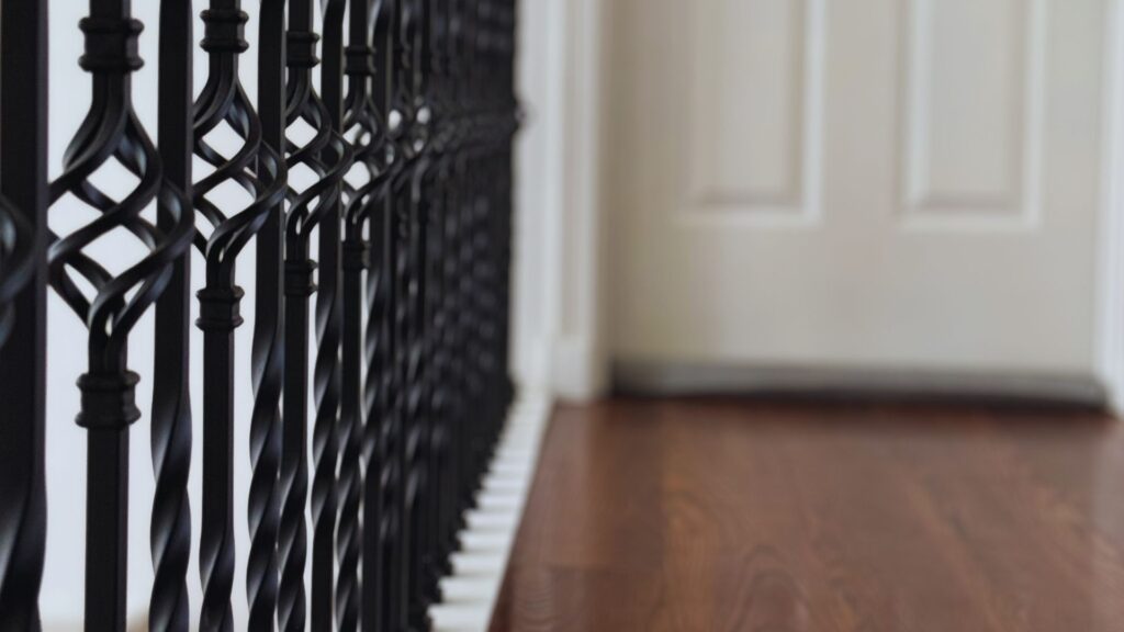close up of wrought iron spindles supports for new staircase following home remodeling